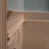 Beadboard With Chair Rail : Beadboard in the Bathroom! - At The Picket Fence - Elegant white and gray bathroom is lit by etoile sconces mounted on either side of a black oblong mirror hung from a wall clad in gray wallpaper over a white beadboard trim lined with a chair rail.