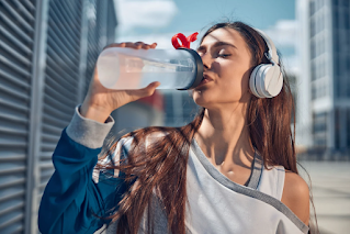 woman drinking from a reusable water bottle | countertop water filters