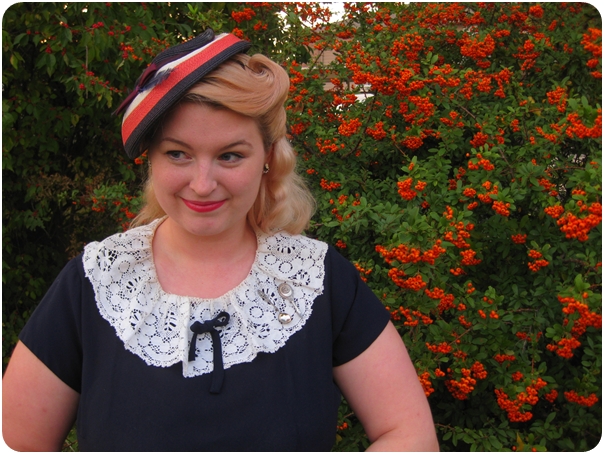 1940s plus size dress with lace collar and victory roll hairstyle with straw vintage hat via Va-Voom Vintage