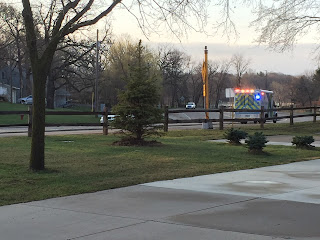 Ambulance with lights on driving down a street.