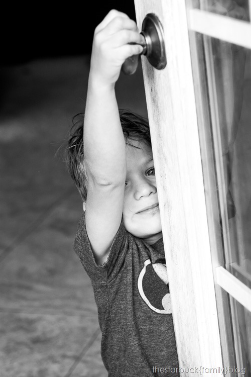 Ryan standing by door black and white blog-3