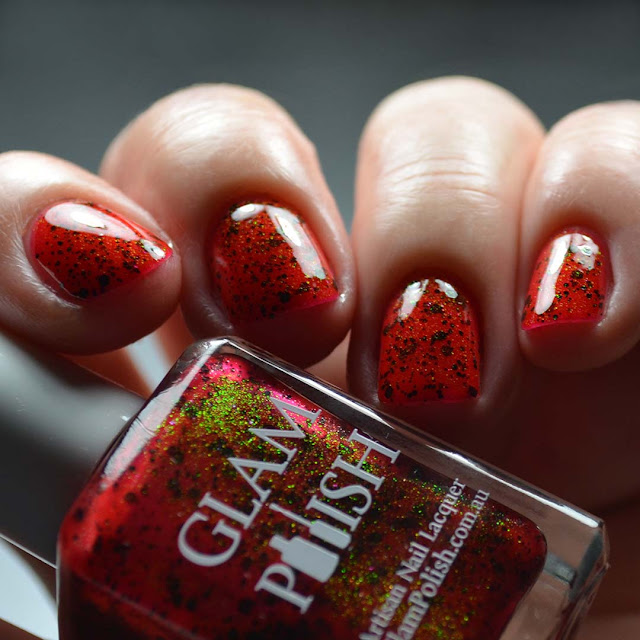 red nail polish with glitter shown in low light