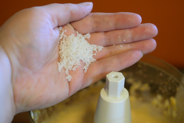 Salt being added to the food processor. 