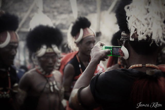 A Khiamniungan Naga man takes video of his friends performing folk dance from his mobile