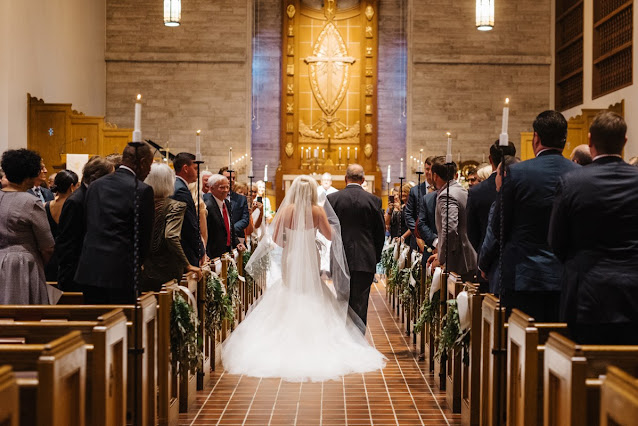 bride and brides father walking down aisle