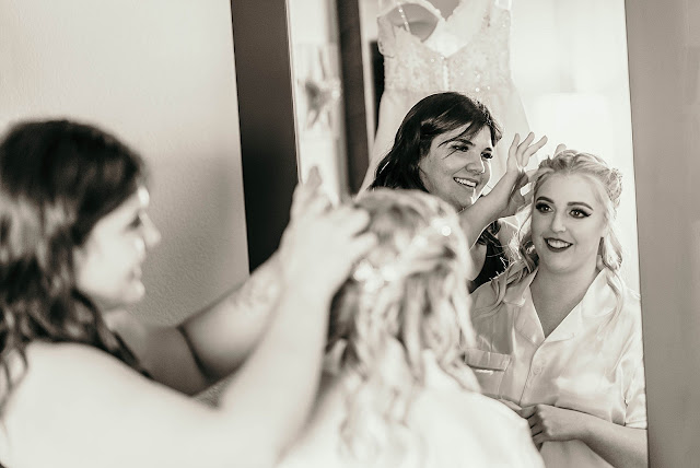 Hair stylist doing Bride's hair Getting ready