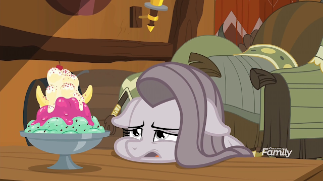 Pinkie with her head laying on the table with a fresh ice cream sundae in front of her.