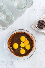 adding eggs to chocolate mixture