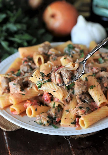 Serving of Pasta in Creamy Sausage Sauce with Fork Image