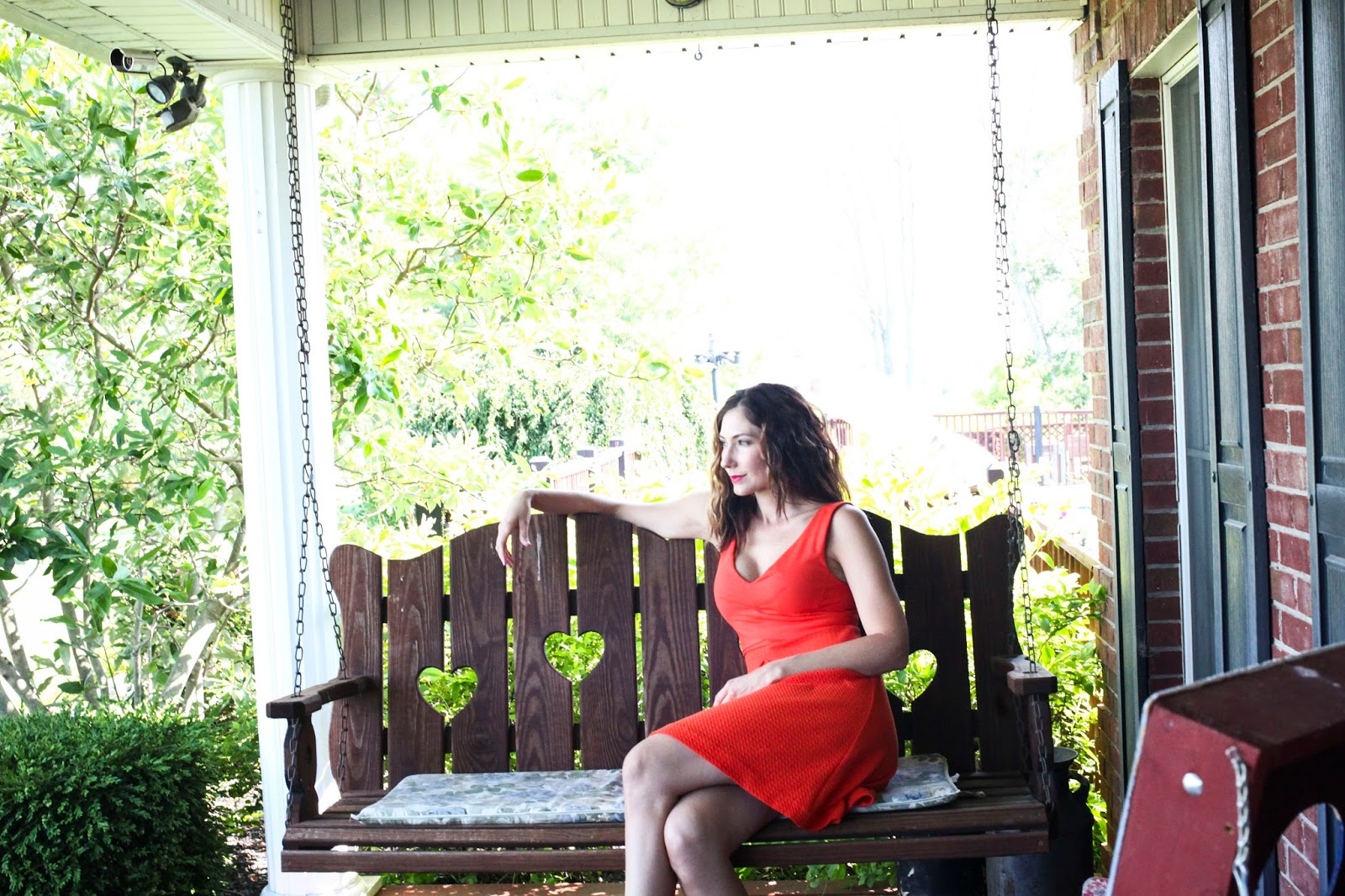 Amy West relaxing on porch swing in Kentucky