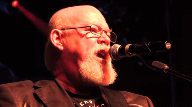 1/3 Bald Bearded Old Daddy Wearing A Gorgeous Leather Blazer Playing Guitar And Singing