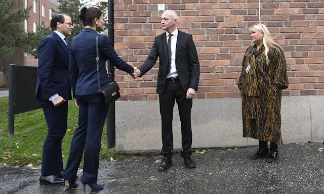 Crown Princess Victoria wore a navy suit, blazer and pants, by Tiger of Sweden, and an Irina blue frilled tie blouse by Mayla Stockholm