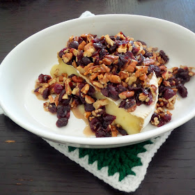 Cranberry Pecan Baked Brie:  A delicious, colorful, and simple holiday appetizer of brie topped with dried cranberries, pecans, and honey.