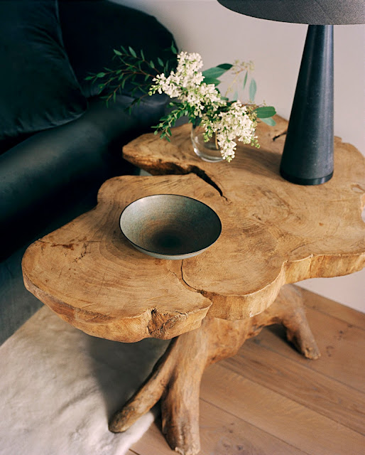 live edge coffee table with fresh flowers, modern lamp, and tray