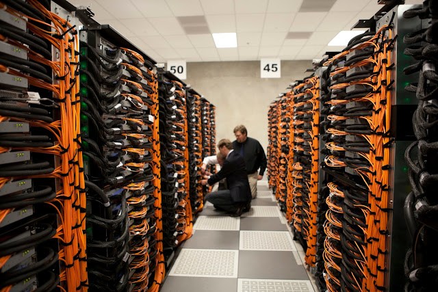 Two technicians in a datacentre aisle