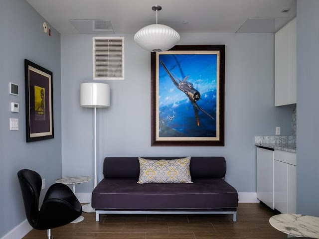 Photo of small room with dark furniture inside of Philadelphia penthouse