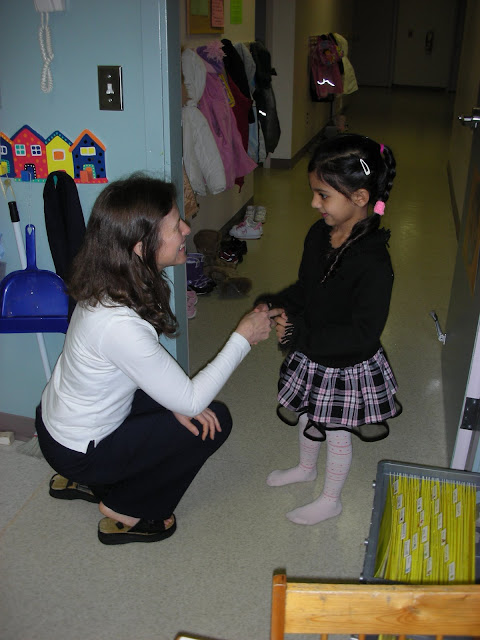 NAMC montessori teacher greets girl montessori prepared environment