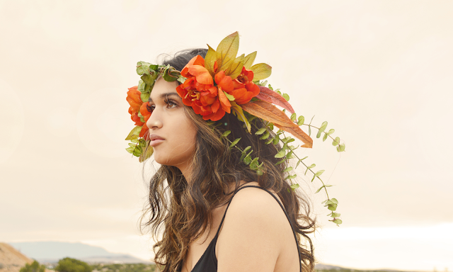 woman looking into sunset with flower crown festival girl