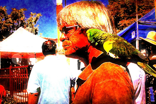 man walking with green parrot on shoulder