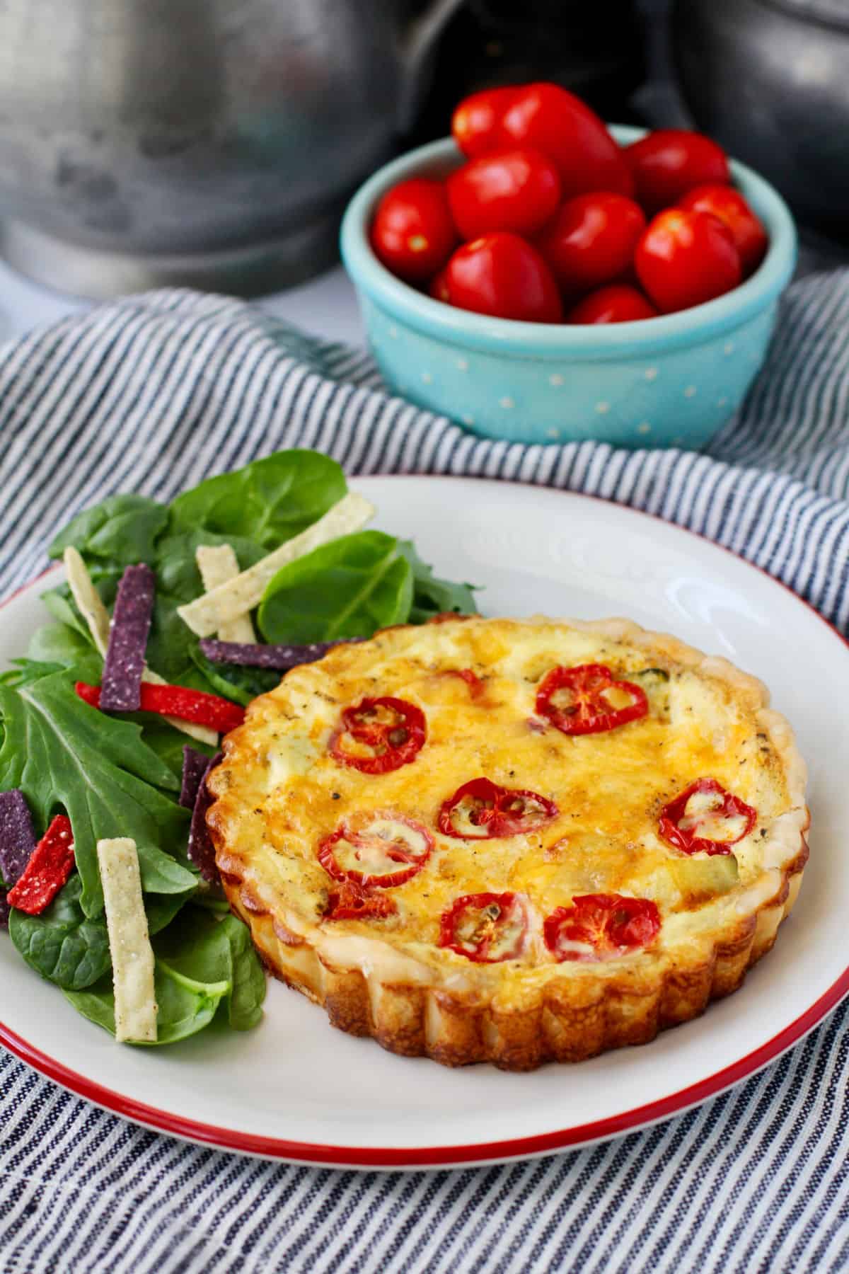 Vegetable and Cheddar Tarts with tomatoes and a salad.
