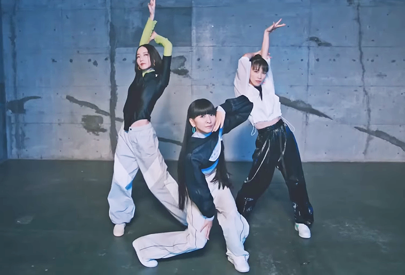 Perfume [From Left to Right: Nocchi, Kashiyuka, a-chan] all wearing athleisure; standing in the ending pose for their song “Moon”.