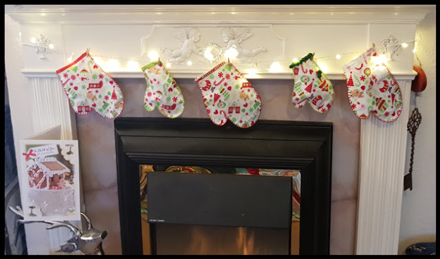 Stuffed mittens round the fireplace for Christmas