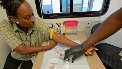 African-American woman doing blood draw