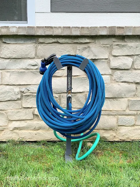 Move outdoor spigot with hose holder