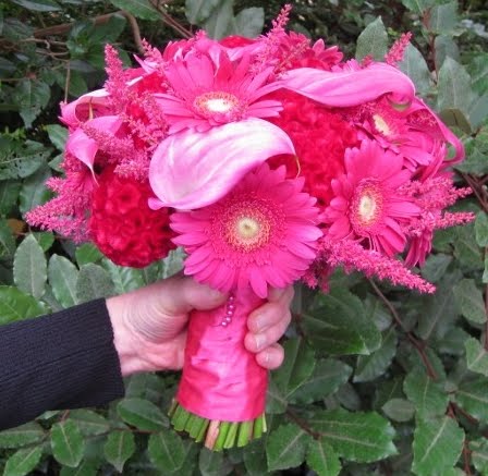 A stunning bridal bouquet of bright pink flowers for a hot pink and lime