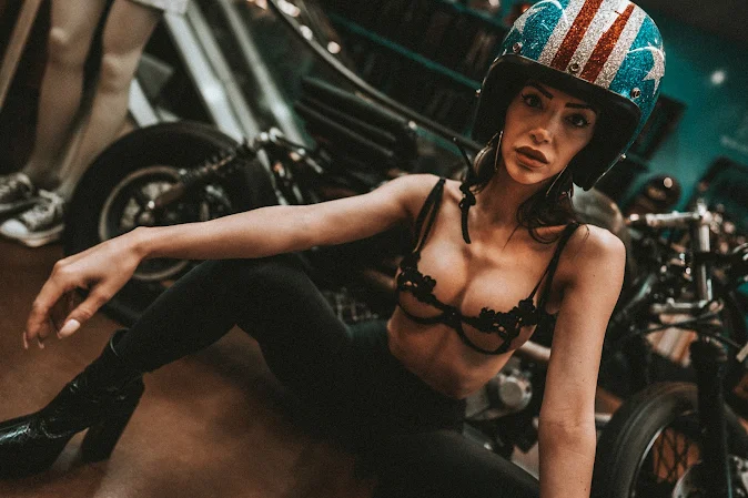 Mya models an open-face helmet with a stars and stripes metalflake paint job.