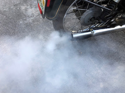 Smoke from motorcycle exhaust pipe.