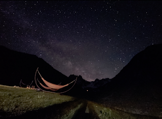 Dark night sky filled with stars and visible Milky Way over the mountains near Juta, Georgia