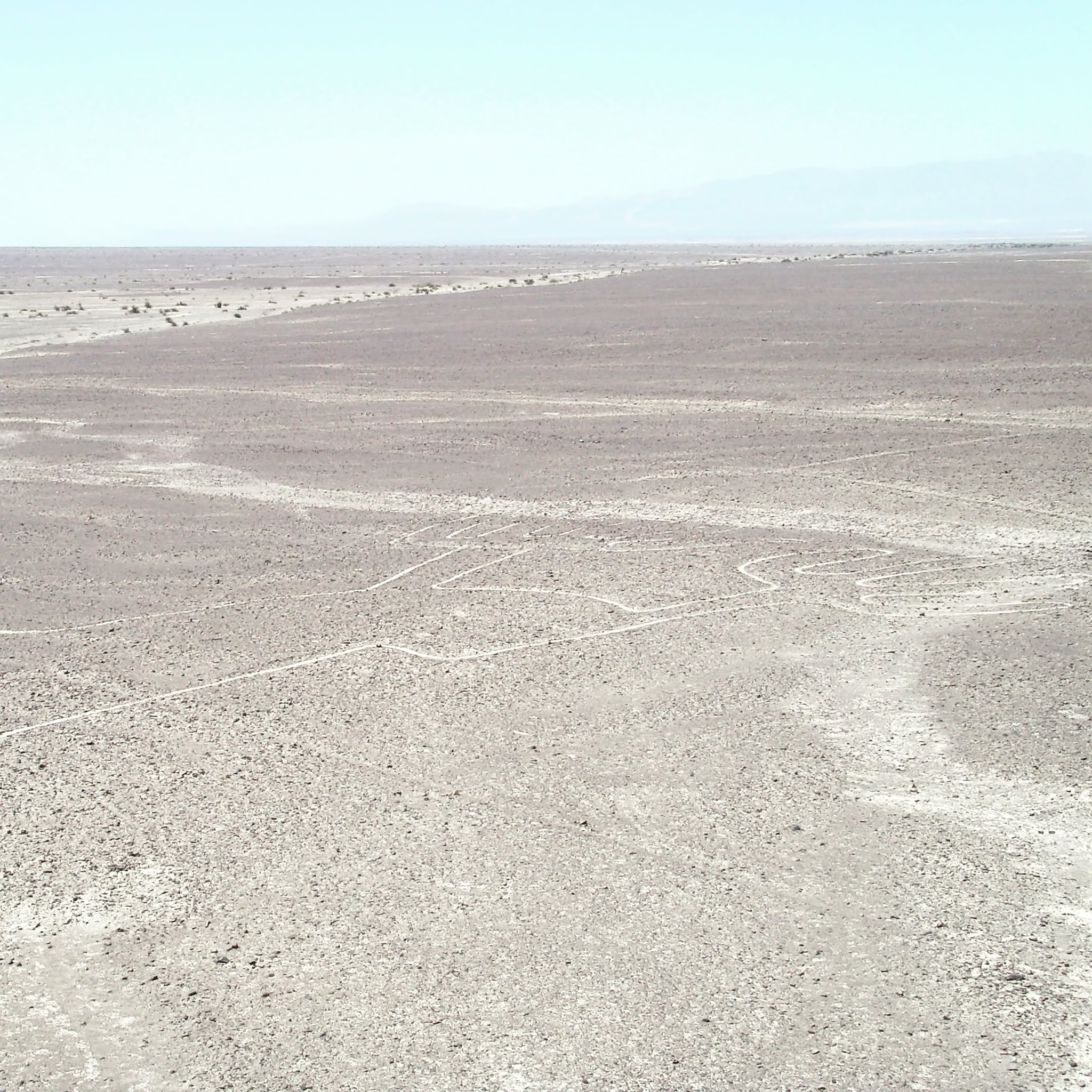 the nazca lines called the hands in the desert of peru. This view is from the viewing platform prioving it's easy to see the nazca lines without flying and on a budget