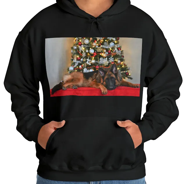 A Hoodie With Black and Red German Shepherd Lying In Front of Christmas Tree With Head Down