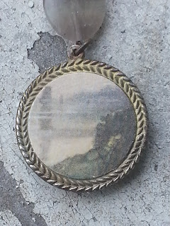 the back of the pendant with vintage ephemera