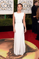 The Danish Girl star Alicia Vikander in white apron dress at the 2016 Golden Globe Awards Red Carpet photo