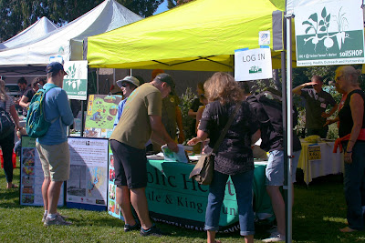 Residents visiting the soilSHOP booth at the Vashon Farmer's Market