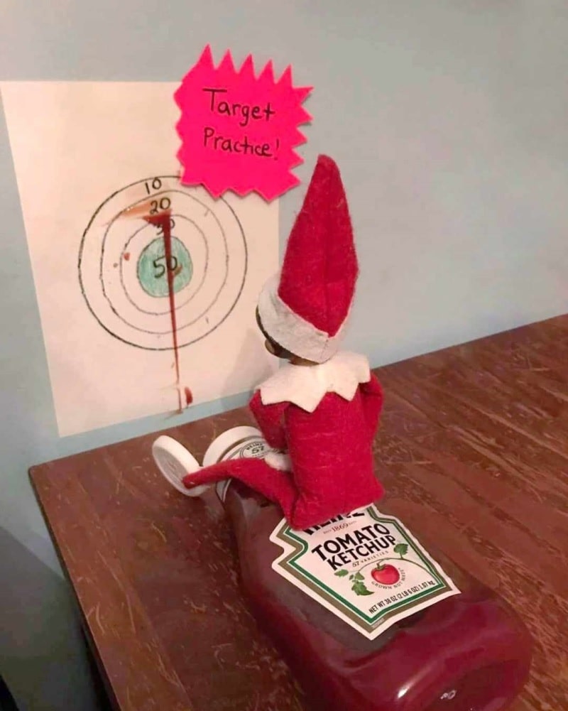 elf using tomato sauce for target practice on wall.