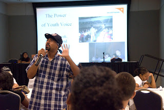 Juan Pacheco wears the attire of his past in the Power of the Youth Voice workshop.