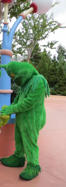 The Grinch Holding a Grinch Plush Islands of Adventure Universal