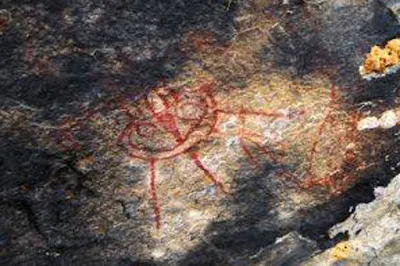 Ancient writing and symbols on cave wall.