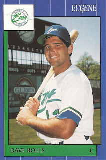 1990 David Rolls Grand Slam baseball card, seen smiling with bat on shoulder