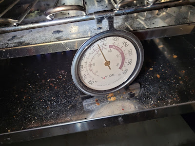 An oven thermometer reads 320 degrees