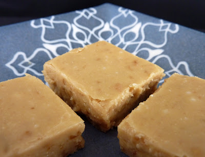 Three pieces of brown sugar/penuche fudge, photographed on a blue snowflake plate.