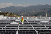 Solar worker (Photograph Credit: David McNew | Getty) Click to Enlarge.