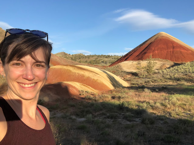 woman in front of colorful rock formations