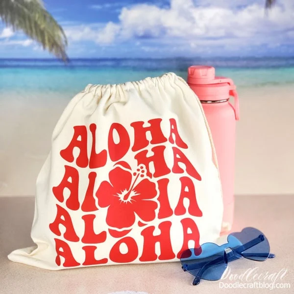Aloha Bag with HTVRONT Heat Press!  Watch how easy and fast it is to customize a drawstring bag with HTV and HTVRont Heat Press!   As soon as Spring hits, I'm already dreaming of Summertime. I love everything to do with the beach, hibiscus flowers and a lot of sunshine.   Since we are still getting tons of snow here in Utah, I'm coping by making Summer vibe crafts.   I received products from HTVRont in exchange for this post, affiliate links included.