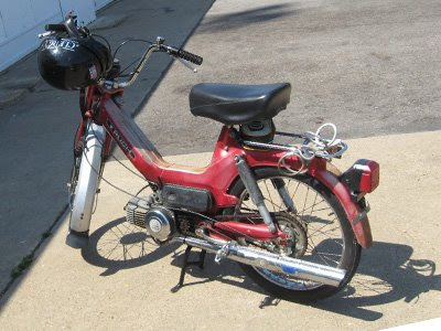 An older Puch moped The helmet has a clergy decal which I have no doubt 