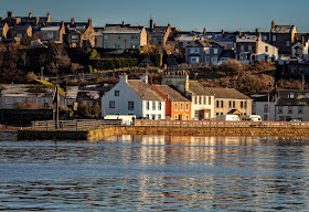 Photo of cottages on North Quay, Maryport, reflected in the still water