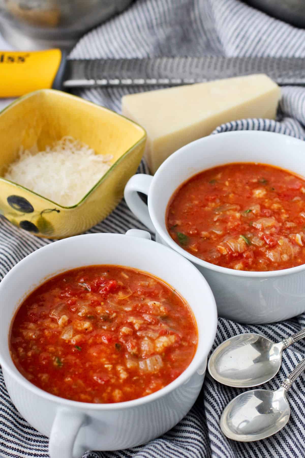 Pappa al Pomodoro (Tomato and Bread Soup) in a bowl with a side of cheese.